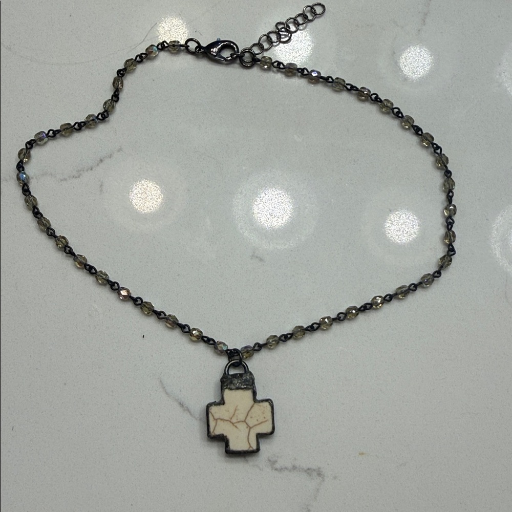 Crystal beaded necklace with a soldered, mother-of-pearl-look cross pendant